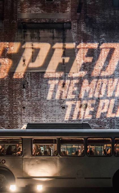 Speed: The Movie, The Play logo projected on a wall
