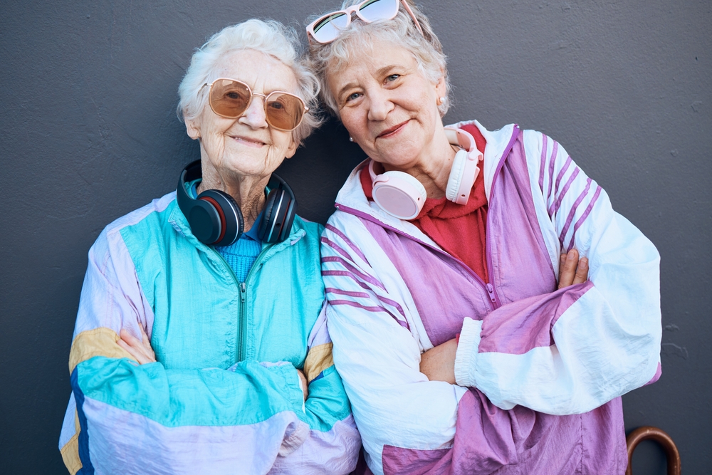 Two senior women standing next to each other wearing retro exercise clothes