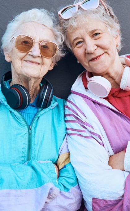 Two senior women standing next to each other wearing retro exercise clothes