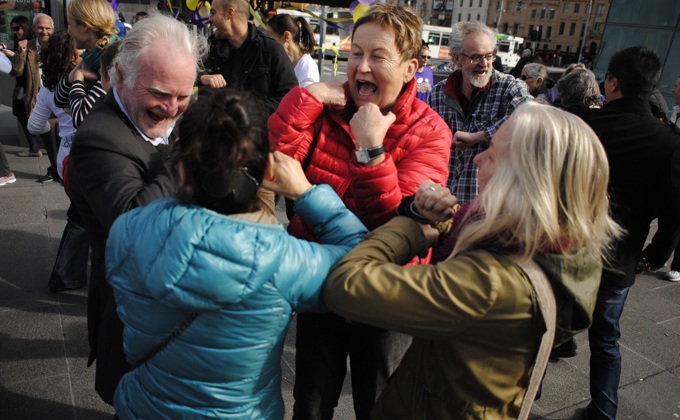 A group of people participating in a Laughter Yoga session