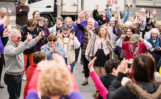 A group of people participating in a Laughter Yoga session