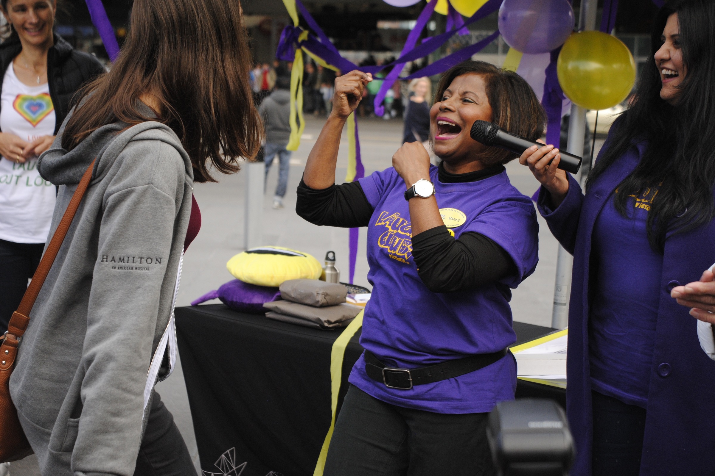 A group of people laughing at a Laughter Yoga event