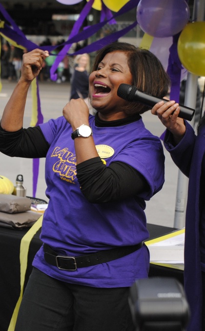 A group of people laughing at a Laughter Yoga event