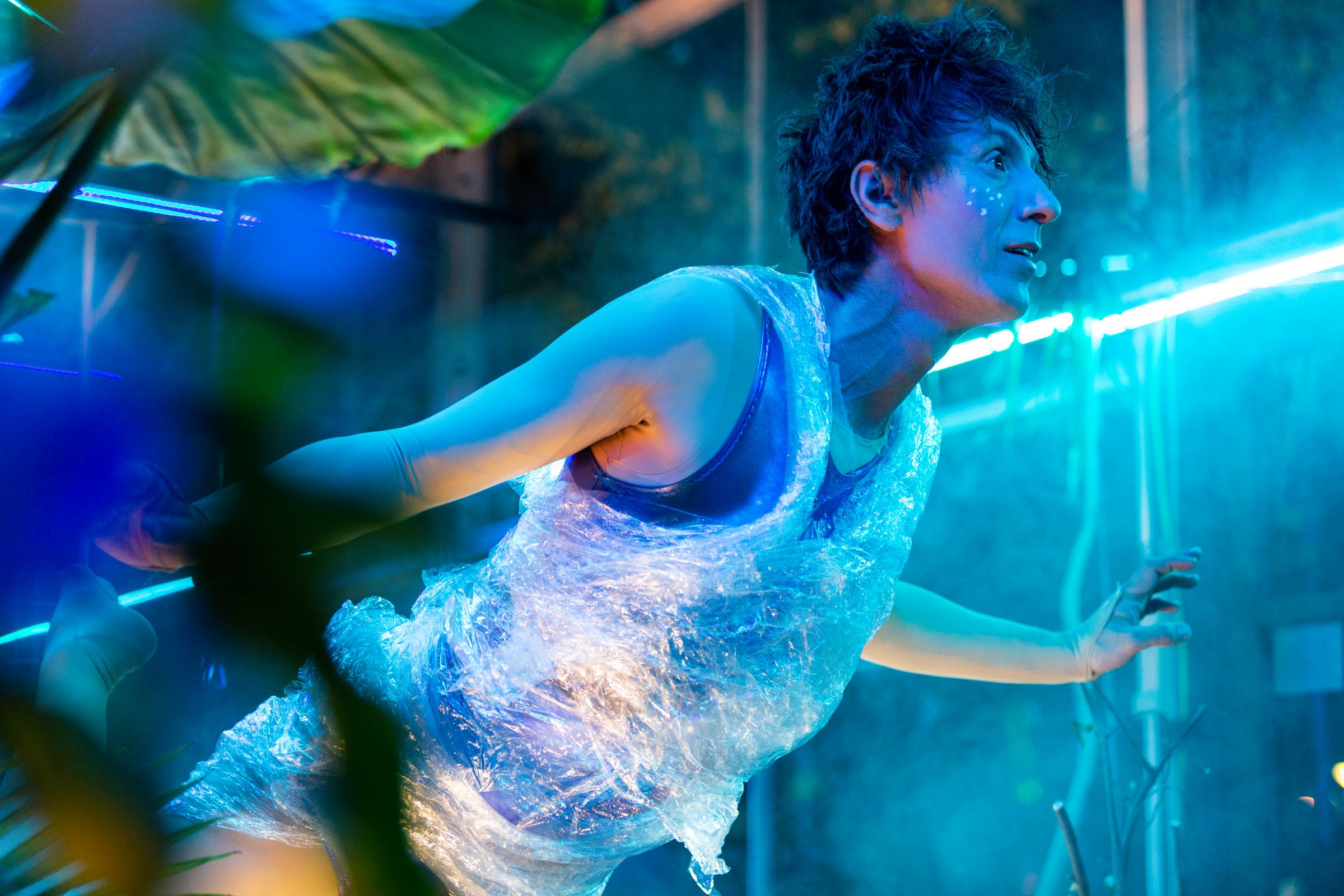 A person performing wearing a bubble wrap garment