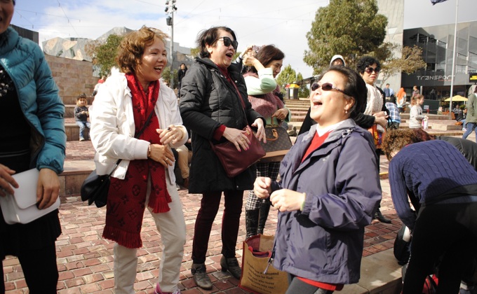 A group of people laughing in a public space